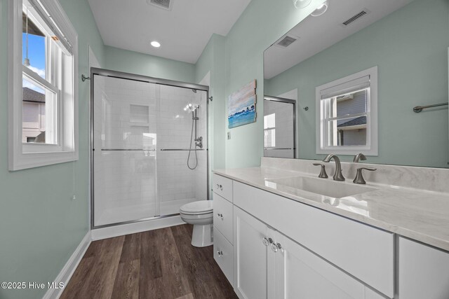 130 N Permuda Wynd Dr, North Topsail Beach, NC 28460 - bathroom featuring toilet, a stall shower, wood finished floors, vanity, and baseboards