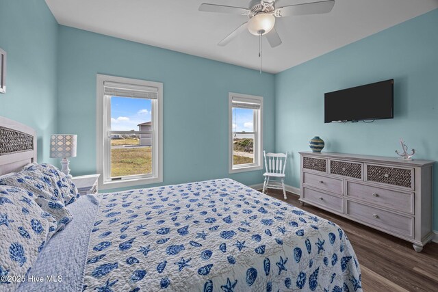 130 N Permuda Wynd Dr, North Topsail Beach, NC 28460 - bedroom with baseboards, dark wood-type flooring, and a ceiling fan