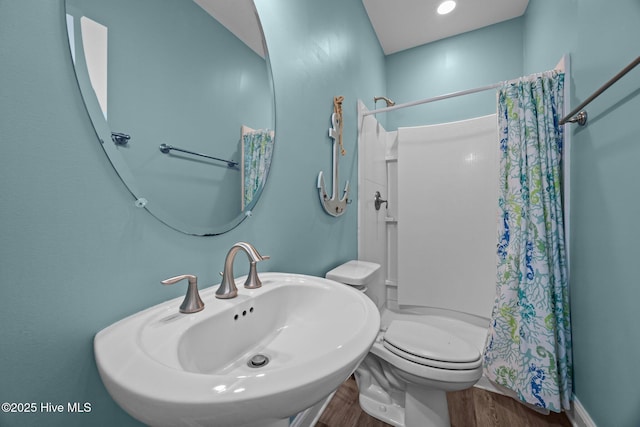 130 N Permuda Wynd Dr, North Topsail Beach, NC 28460 - full bath featuring wood finished floors, a shower with shower curtain, a sink, and toilet