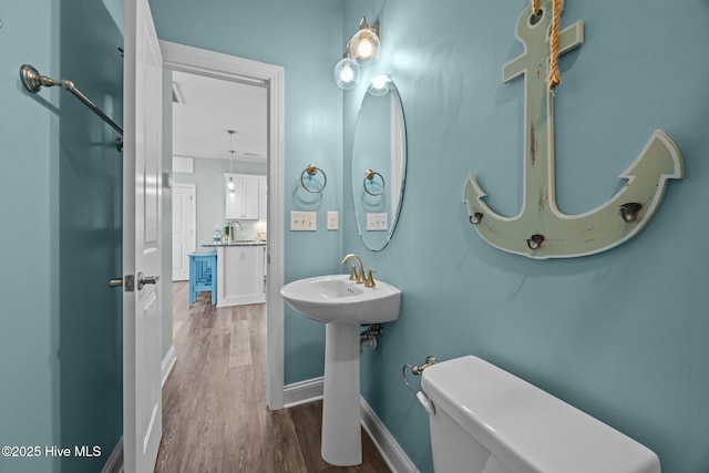 130 N Permuda Wynd Dr, North Topsail Beach, NC 28460 - bathroom featuring wood finished floors, a sink, baseboards, and toilet