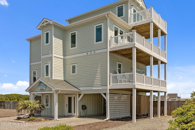 130 N Permuda Wynd Dr, North Topsail Beach, NC 28460 - rear view of property with a balcony, a carport, fence, and driveway