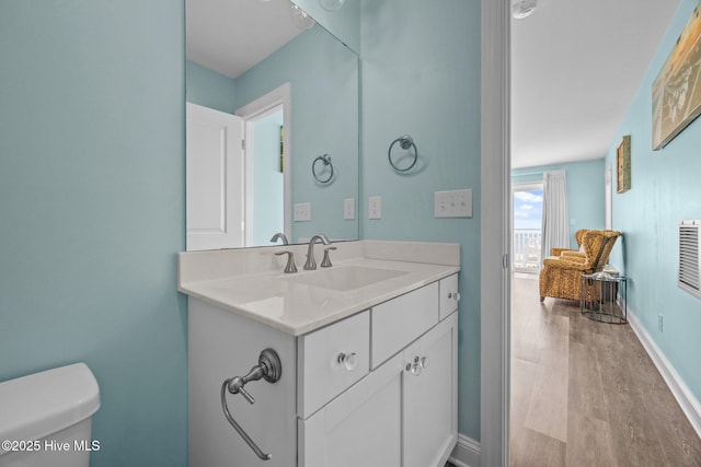 130 N Permuda Wynd Dr, North Topsail Beach, NC 28460 - half bathroom featuring wood finished floors, toilet, vanity, and baseboards