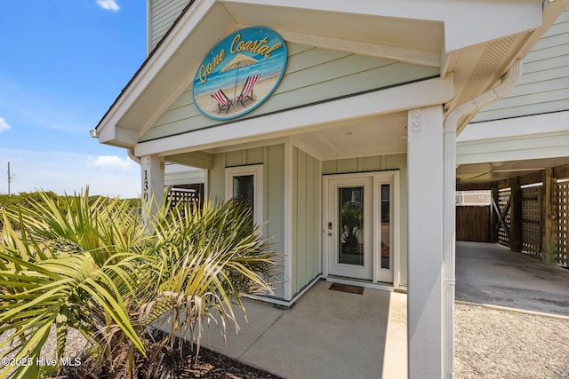 130 N Permuda Wynd Dr, North Topsail Beach, NC 28460 - doorway to property with board and batten siding