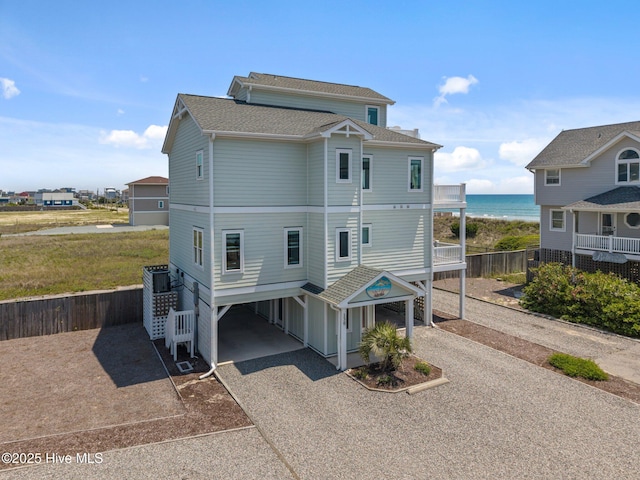 130 N Permuda Wynd Dr, North Topsail Beach, NC 28460 - back of house featuring a carport, driveway, a water view, and roof with shingles