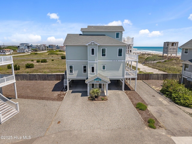 130 N Permuda Wynd Dr, North Topsail Beach, NC 28460 - beach home with a carport, gravel driveway, roof with shingles, a water view, and stairway