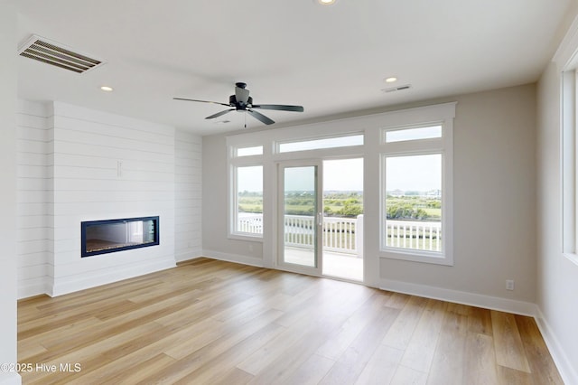 128 Sea Oaks Ct, North Topsail Beach, NC 28460 - unfurnished living room with baseboards, a large fireplace, light wood-style floors, recessed lighting, and ceiling fan