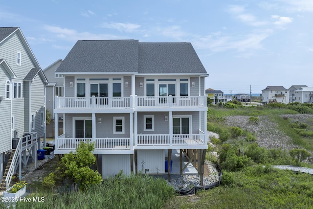 128 Sea Oaks Ct, North Topsail Beach, NC 28460 - rear view of property with a shingled roof and a balcony
