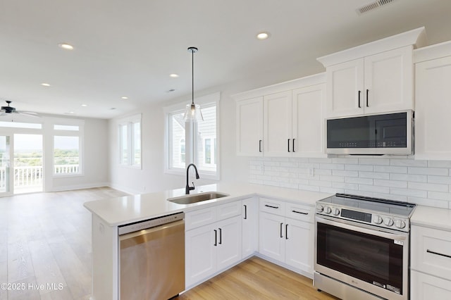 128 Sea Oaks Ct, North Topsail Beach, NC 28460 - kitchen featuring appliances with stainless steel finishes, a sink, ceiling fan, light countertops, and recessed lighting