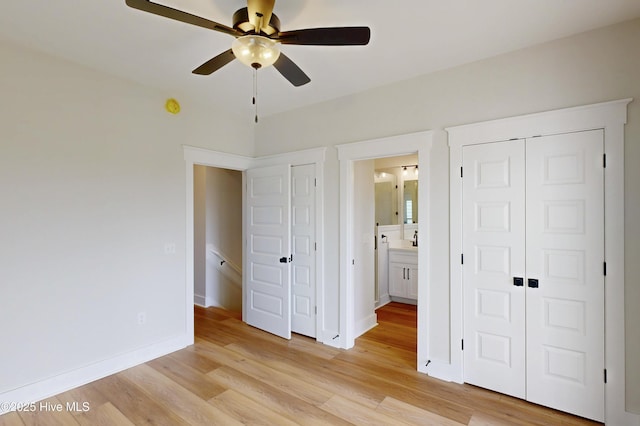 128 Sea Oaks Ct, North Topsail Beach, NC 28460 - unfurnished bedroom featuring light wood-style flooring, baseboards, ceiling fan, and ensuite bathroom