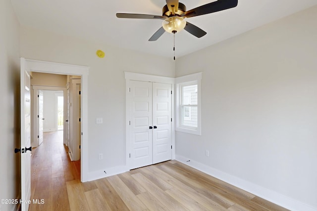 128 Sea Oaks Ct, North Topsail Beach, NC 28460 - unfurnished bedroom featuring light wood finished floors, a closet, baseboards, and ceiling fan
