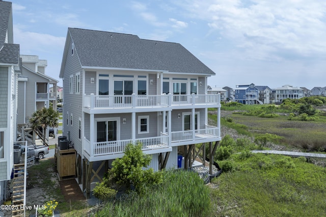 128 Sea Oaks Ct, North Topsail Beach, NC 28460 - rear view of property with a shingled roof, a balcony, a residential view, and cooling unit