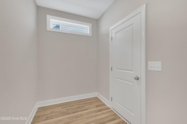 doorway to outside with light wood-type flooring and baseboards