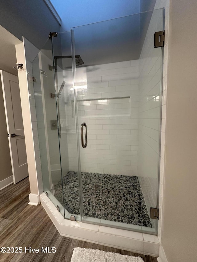 565 Salter Path Rd Unit S-5, Pine Knoll Shores, NC 28512 - full bathroom with wood finished floors, a stall shower, and baseboards