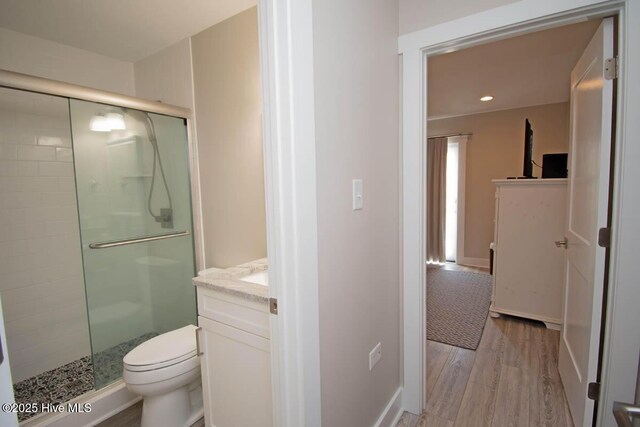 565 Salter Path Rd Unit S-5, Pine Knoll Shores, NC 28512 - bathroom with a shower stall, vanity, toilet, wood finished floors, and baseboards