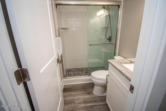565 Salter Path Rd Unit S-5, Pine Knoll Shores, NC 28512 - full bath featuring a shower stall, toilet, vanity, and wood finished floors