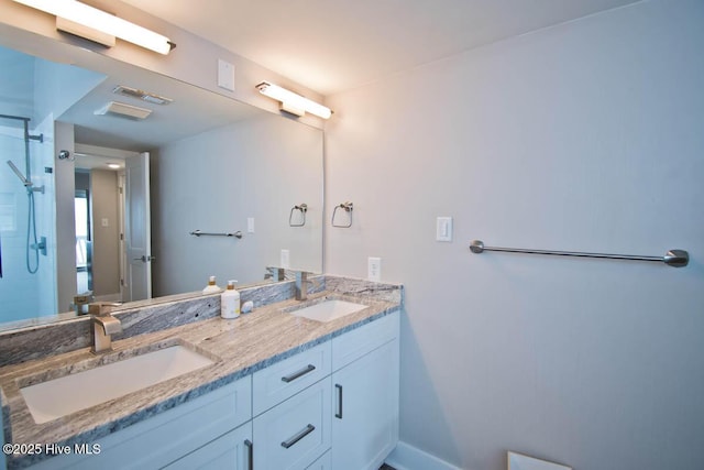 565 Salter Path Rd Unit S-5, Pine Knoll Shores, NC 28512 - bathroom with double vanity, a shower, and baseboards
