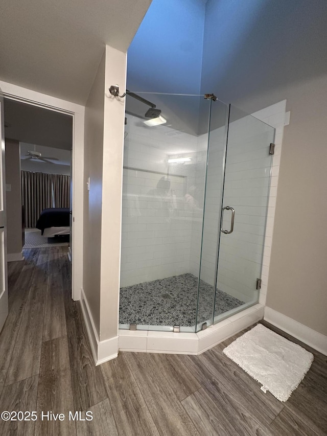 565 Salter Path Rd Unit S-5, Pine Knoll Shores, NC 28512 - ensuite bathroom with wood finished floors, baseboards, a stall shower, and a ceiling fan