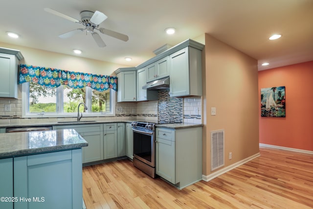 265 Creek View Dr, Sunset Beach, NC 28468 - kitchen with a sink, appliances with stainless steel finishes, light wood-type flooring, tasteful backsplash, and under cabinet range hood