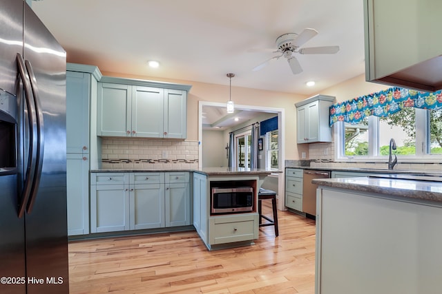265 Creek View Dr, Sunset Beach, NC 28468 - kitchen featuring appliances with stainless steel finishes, backsplash, a peninsula, ceiling fan, and recessed lighting