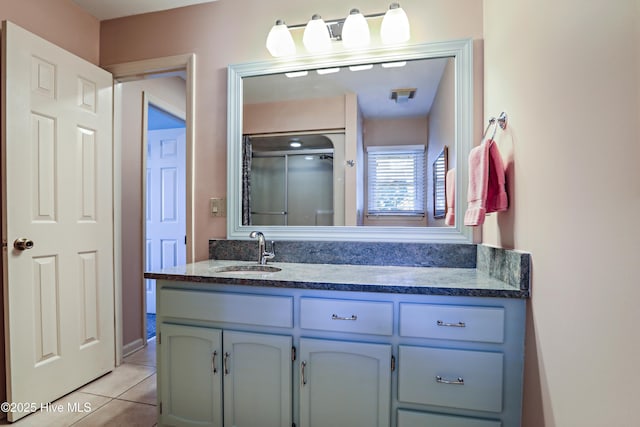 265 Creek View Dr, Sunset Beach, NC 28468 - bathroom featuring vanity, tile patterned floors, and a shower with shower door