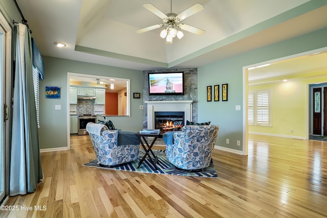 265 Creek View Dr, Sunset Beach, NC 28468 - living area with a fireplace, light wood-style floors, a ceiling fan, and baseboards