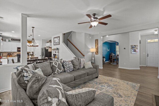 140 Timberwood Dr, Cameron, NC 28326 - living area with ceiling fan, arched walkways, wood finished floors, stairway, and baseboards