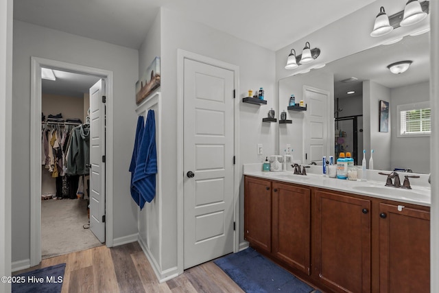 140 Timberwood Dr, Cameron, NC 28326 - full bath with wood finished floors, a stall shower, double vanity, and a walk in closet