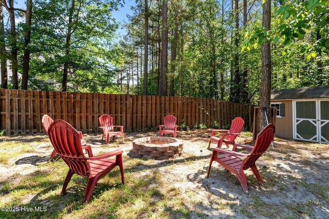 140 Timberwood Dr, Cameron, NC 28326 - view of yard featuring an outdoor fire pit, a storage unit, fence, and an outdoor structure