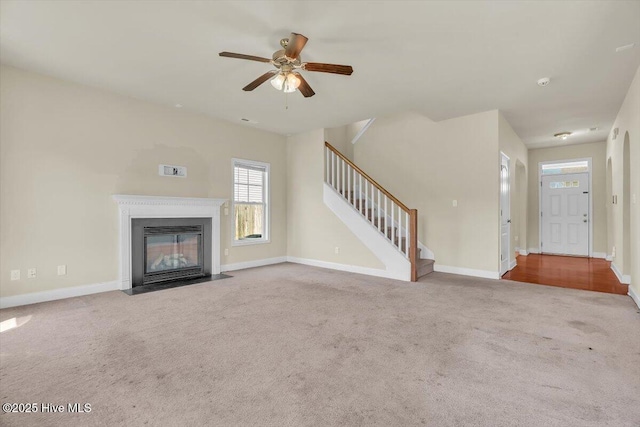132 Turquoise Dr, Jacksonville, NC 28546 - unfurnished living room with carpet flooring, stairway, a ceiling fan, and baseboards