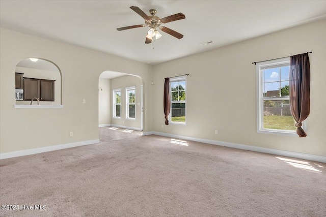 132 Turquoise Dr, Jacksonville, NC 28546 - carpeted spare room with baseboards, ceiling fan, and arched walkways