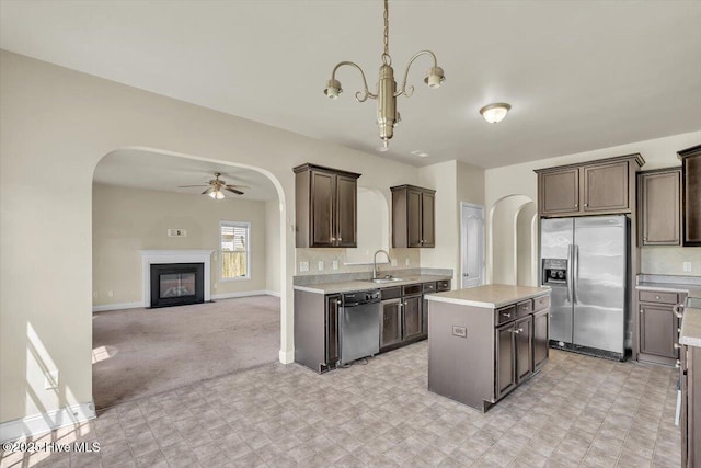 132 Turquoise Dr, Jacksonville, NC 28546 - kitchen with appliances with stainless steel finishes, arched walkways, dark brown cabinets, and a ceiling fan