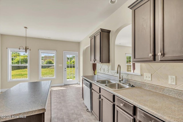 132 Turquoise Dr, Jacksonville, NC 28546 - kitchen with a sink, arched walkways, stainless steel dishwasher, and tasteful backsplash