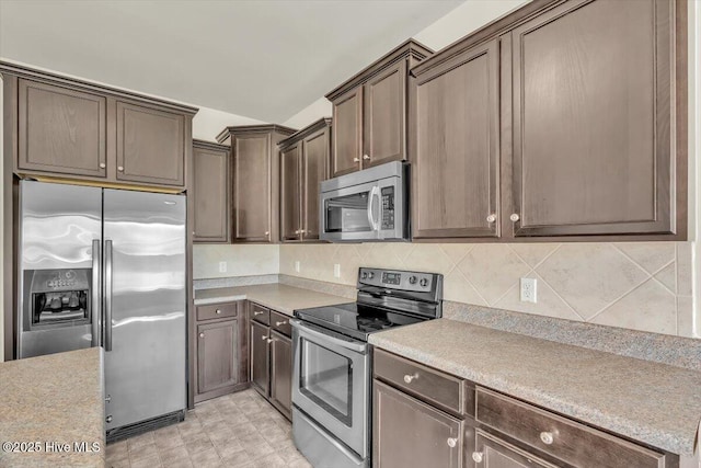 132 Turquoise Dr, Jacksonville, NC 28546 - kitchen featuring appliances with stainless steel finishes, light countertops, dark brown cabinetry, and backsplash