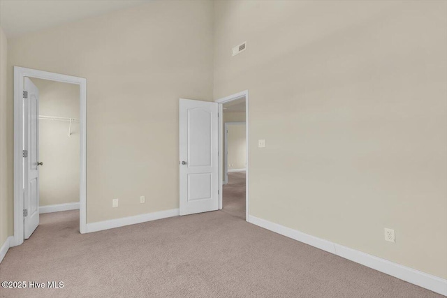 132 Turquoise Dr, Jacksonville, NC 28546 - unfurnished bedroom with carpet, baseboards, a spacious closet, and a closet