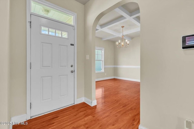 132 Turquoise Dr, Jacksonville, NC 28546 - foyer entrance with coffered ceiling, arched walkways, wood finished floors, baseboards, and beamed ceiling