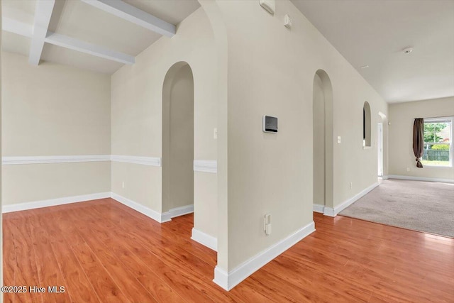 132 Turquoise Dr, Jacksonville, NC 28546 - empty room with arched walkways, light wood finished floors, baseboards, and beamed ceiling