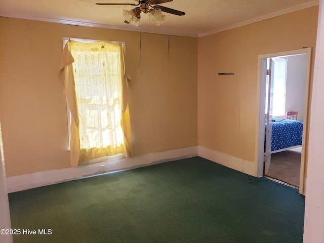 809 Conway Rd, Fair Bluff, NC 28439 - spare room featuring crown molding, ceiling fan, dark colored carpet, and baseboards