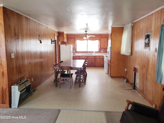 809 Conway Rd, Fair Bluff, NC 28439 - dining space featuring wooden walls, a ceiling fan, light flooring, baseboards, and crown molding