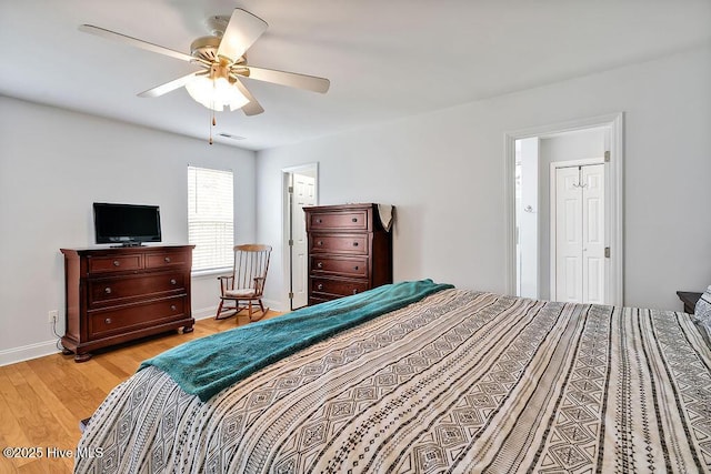 bedroom featuring light wood-style flooring, baseboards, and ceiling fan