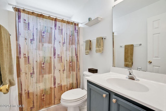 bathroom with toilet, vanity, and a shower with curtain
