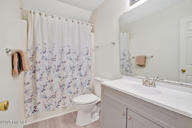 full bath with toilet, wood finished floors, vanity, and shower / bath combination with curtain