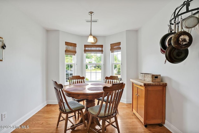 dining room featuring baseboards and light wood-style floors