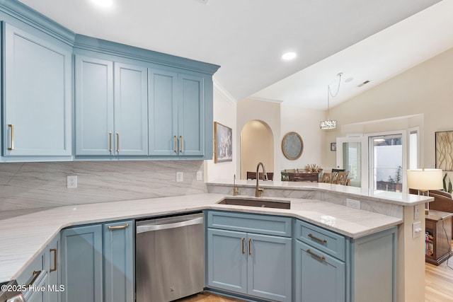 kitchen with dishwasher, a sink, a peninsula, blue cabinetry, and vaulted ceiling