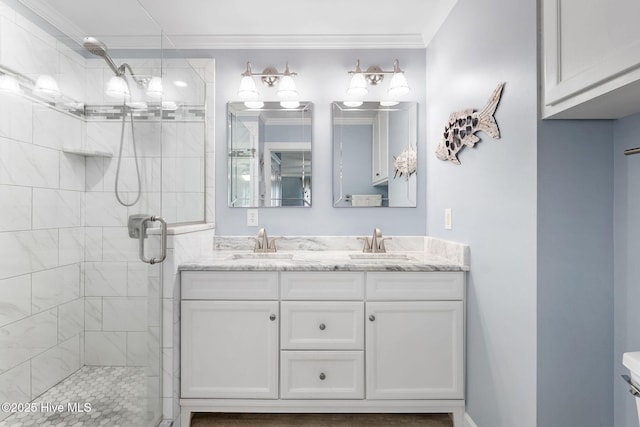 bathroom with crown molding, a shower stall, and double vanity