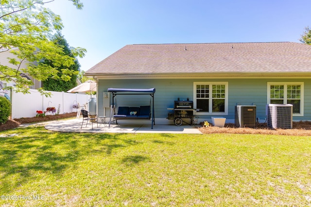 rear view of property featuring central AC, a patio area, and roof with shingles
