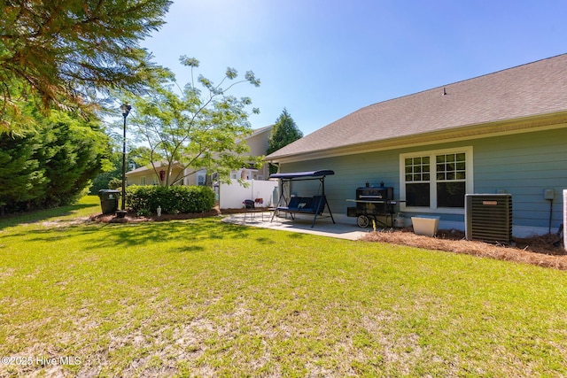 back of house with a patio area, central air condition unit, and a yard