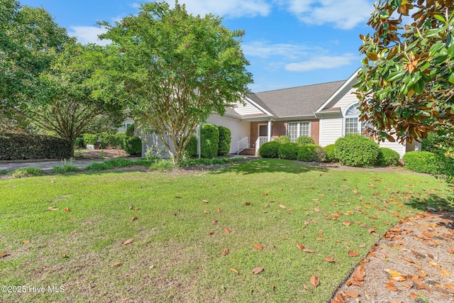view of front of house featuring a front lawn and a shingled roof