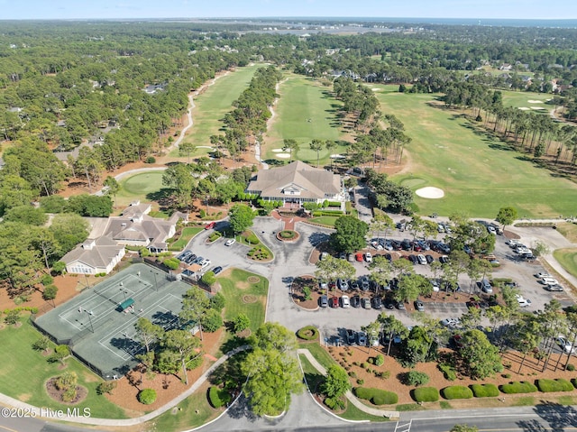 aerial view of property and surrounding area with a golf club