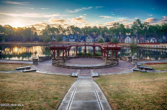 surrounding community featuring a water view, a yard, and a pergola