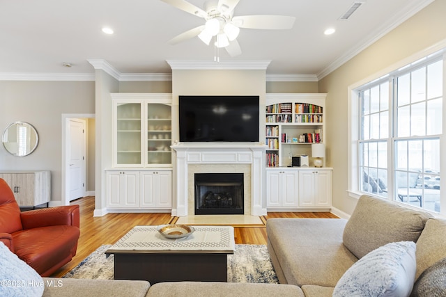2016 Ashbrook Ct, Leland, NC 28451 - living area featuring radiator, ceiling fan, baseboards, crown molding, and a premium fireplace